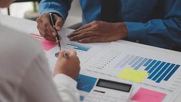 Financial analysts analyze business financial reports on a digital tablet planning investment project during a discussion at a meeting of corporate showing the results of their successful teamwork. video