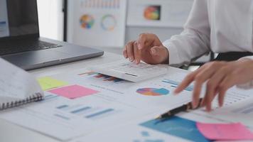 Financial analysts analyze business financial reports on a digital tablet planning investment project during a discussion at a meeting of corporate showing the results of their successful teamwork. video