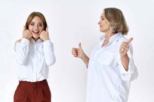 cheerful mom and daughter in white shirts embrace lifestyle photo