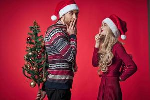 man and woman christmas holiday romance red background photo