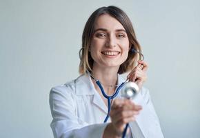 nurse in a medical gown and a stethoscope around her neck smile portrait photo