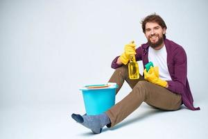 Cleaner with a bucket on the floor professional detergent service photo