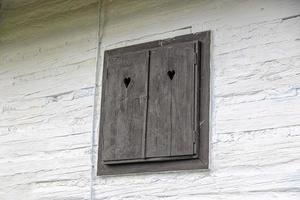 wooden closed shutter on a white historic building photo