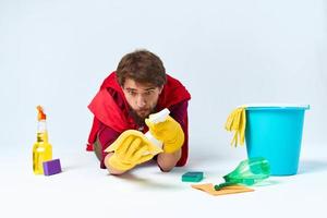 Man on the floor cleaning the house cleaning supplies Professional photo