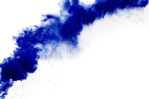 Bizarre forms of blue powder explode cloud on white background. Launched blue dust particles splashing. photo