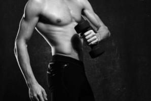 man with a pumped-up torso muscles dumbbells exercise gym photo