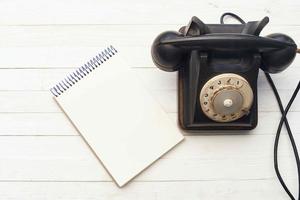 retro telephone he communication office notepad wooden background object photo