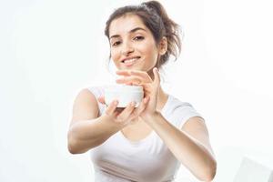 woman with cream on her hands skin care cosmetics dermatology photo