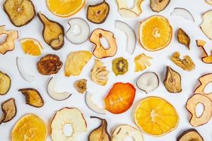 Dried fruits isolated on white background. Healthy eating concept. Top view. Healthy vegetarian food concept. Dried fruit chips. photo