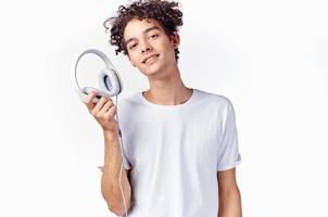 man with curly hair and in headphones listens to music photo