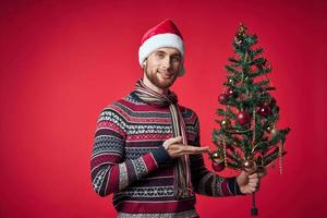 Cheerful man in a santa hat Christmas decorations holiday New Year studio posing photo