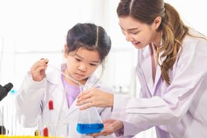 Elementary science class, Kid girl with teacher scientist in school laboratory, Science laboratory photo