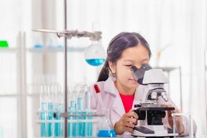 Elementary science class, Cheerful kid girl in school laboratory, Science laboratory photo