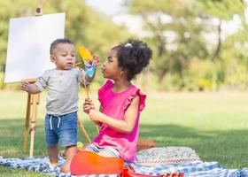 Brother and sister playing outdoor, Cute children are playing in park, Boy and girl play in yard photo