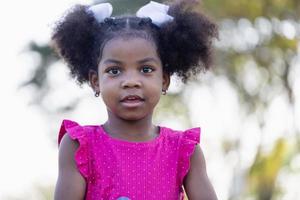 Cute little kid girl playing outdoors in the garden, Child girl in the park photo