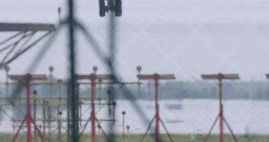 an airplane landing at barcelona airport shot with a tele zoom lens to focus close on the runway video