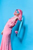 fashionable woman in sunglasses wears a pink wig studio model unaltered photo