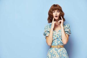 Woman in flower dress Surprised look open mouth short hair photo