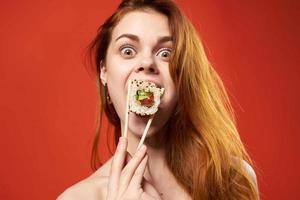 emotional woman with chopsticks sushi rolls snack photo