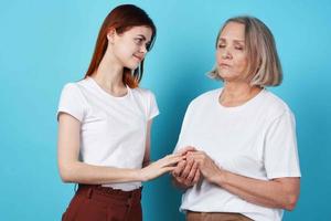 Mom and daughter hold hands in white t-shirts family together photo