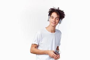 joyful guy in headphones listens to music emotions light background photo