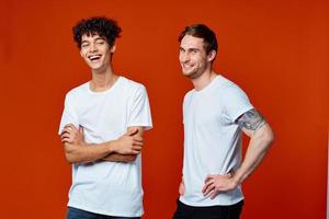 funny two men in white t-shirts on a red background friendship photo