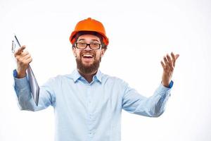 Cheerful man in orange hard hat construction documents service professionals photo