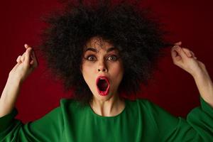 Positive young woman with curly hair grimace posing emotion studio model unaltered photo