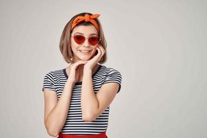 cheerful woman in sunglasses with a bandage on her head fashion posing photo