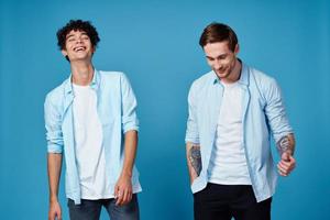 friends in identical clothes on blue background gesturing with hands cropped view photo