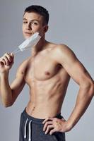 sporty man with muscular body medical mask posing photo