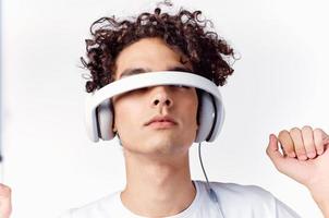 Cheerful man with curly hair in headphones listens to music emotions photo