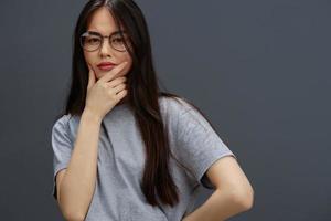 portrait woman in round glasses smile posing close-ups Gray background photo