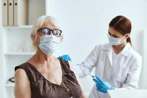 elderly woman wearing a medical mask in the hospital for vaccinations covid-19 passport photo
