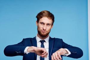 cheerful business man in a suit gesturing with his hands emotions studio photo