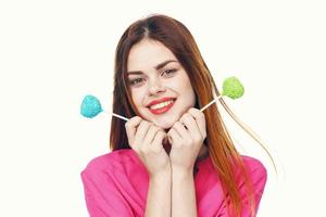 pretty woman holding lollipops pink ferris shirt glamor light background photo