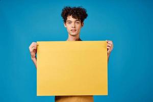 curly guy with yellow mockup poster blue background photo