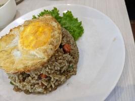 Fried rice the traditional food of Indonesia with lettuce and egg. The photo is suitable to use for traditional food background, poster and food content media.