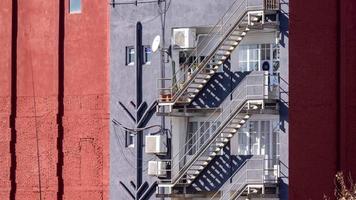 timelapse of shadow passing over emergency steps on side of urban building video