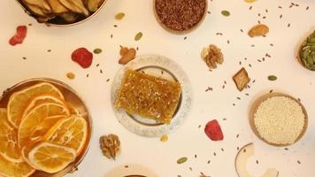 Healthy vegetarian food concept. Assortment of dried fruits, nuts and seeds on white background. Top view. video