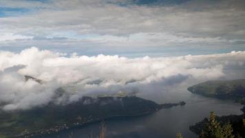 timelapse looking through the clouds down towards annecy lake in the french alps video