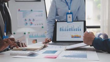 Financial analysts analyze business financial reports on a digital tablet planning investment project during a discussion at a meeting of corporate showing the results of their successful teamwork. video