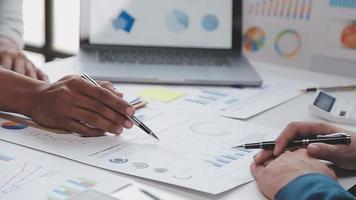 Financial analysts analyze business financial reports on a digital tablet planning investment project during a discussion at a meeting of corporate showing the results of their successful teamwork. video