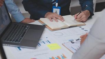 Financial analysts analyze business financial reports on a digital tablet planning investment project during a discussion at a meeting of corporate showing the results of their successful teamwork. video