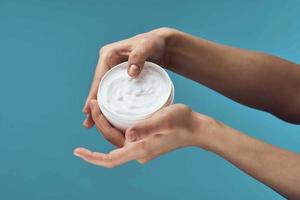 female hand white jar with cream skin care health dermatology photo