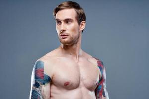 man with tattoo naked torso sport fitness gray background portrait photo