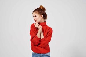 pretty woman in a red sweater light background photo