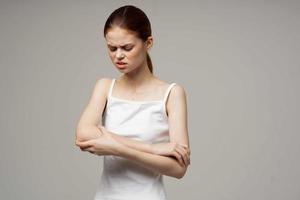 disgruntled woman elbow pain arthritis chronic disease light background photo