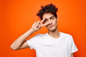 guy with curly hair gestures with his hand emotions modern style photo