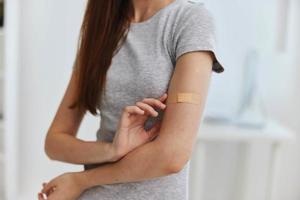 woman in hospital with adhesive tape on shoulder health immunity photo